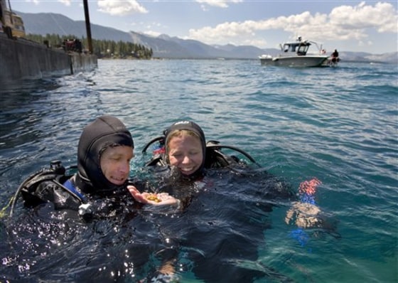 UC Davis research scientists Brant Allen, left, and Marion Wittmann with a handful of Asian clams removed from the bottom of Lake Tahoe.